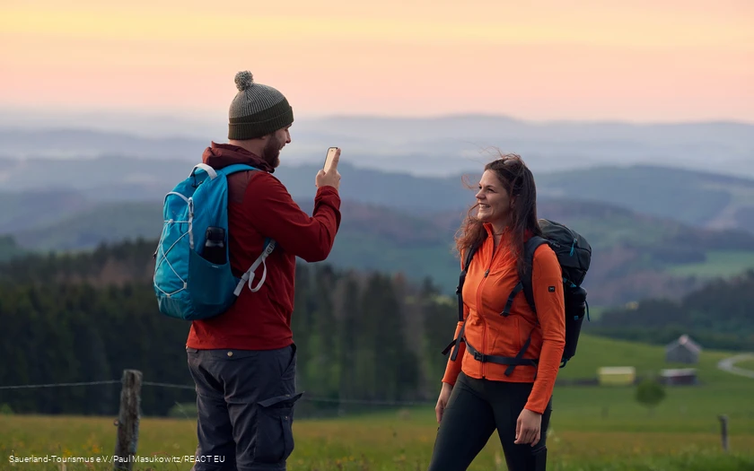 Ein Wanderer macht eine Handyaufnahme am Krutenberg in Medebach