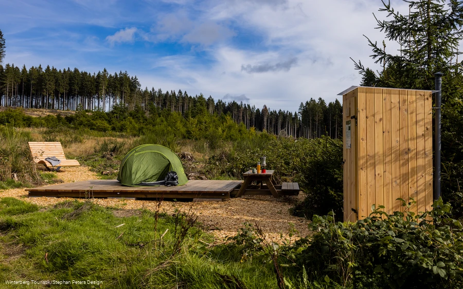 Blick auf den Trekkingplatz in Niedersfeld mit Zeltplatz, Bank und Komposttoilette